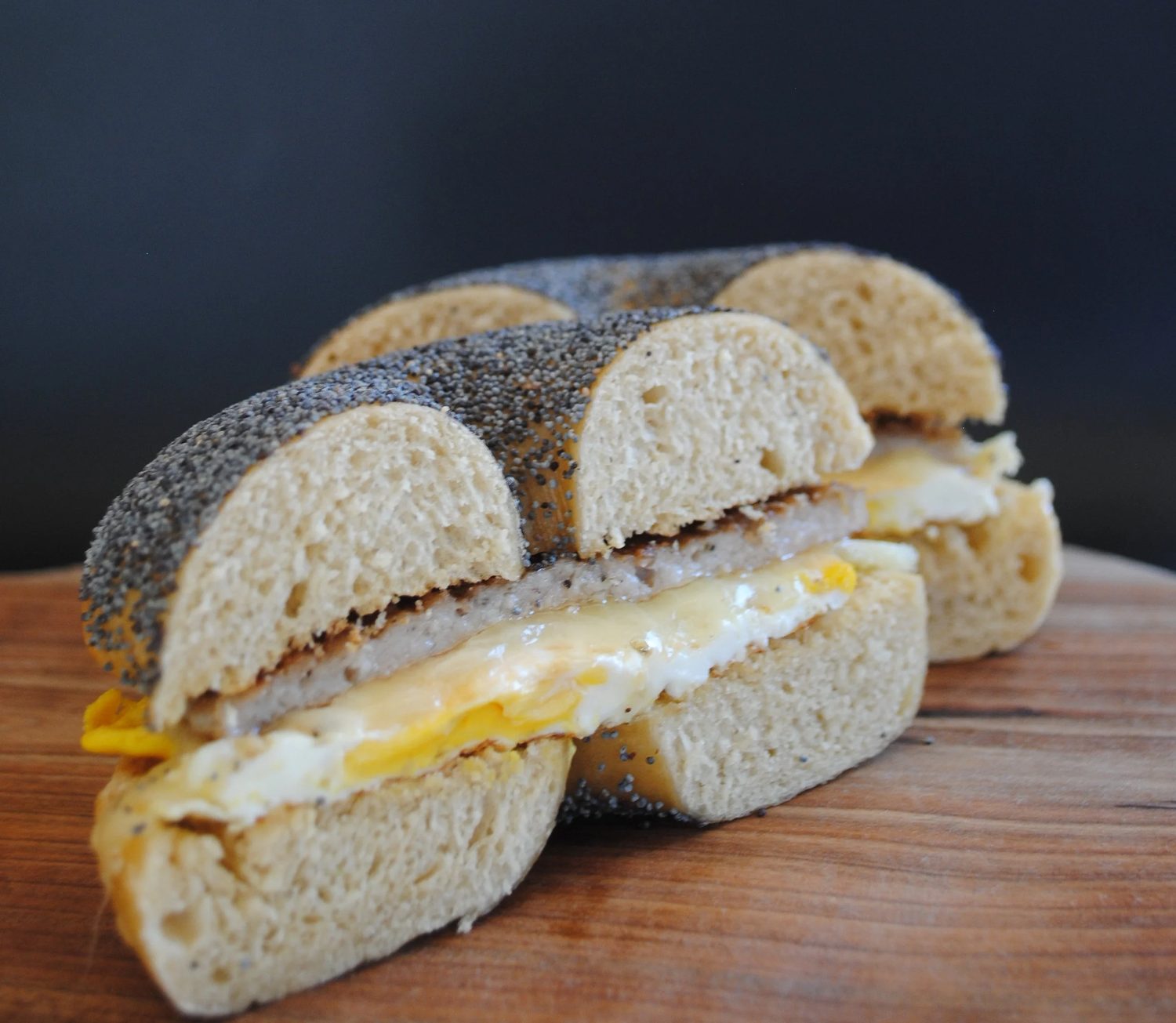 An everything-bagel breakfast sandwich cut in half