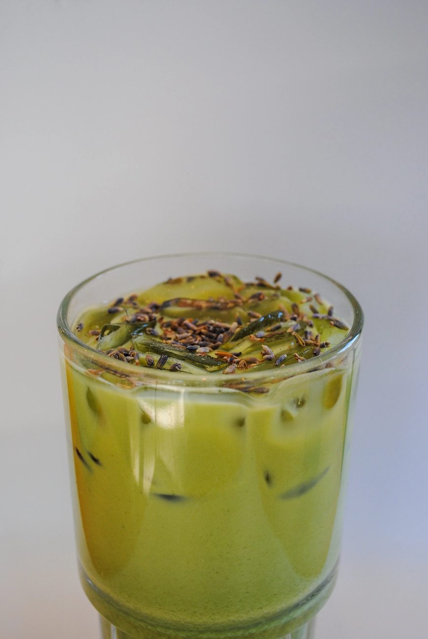 A tall iced matcha latté in a glass
